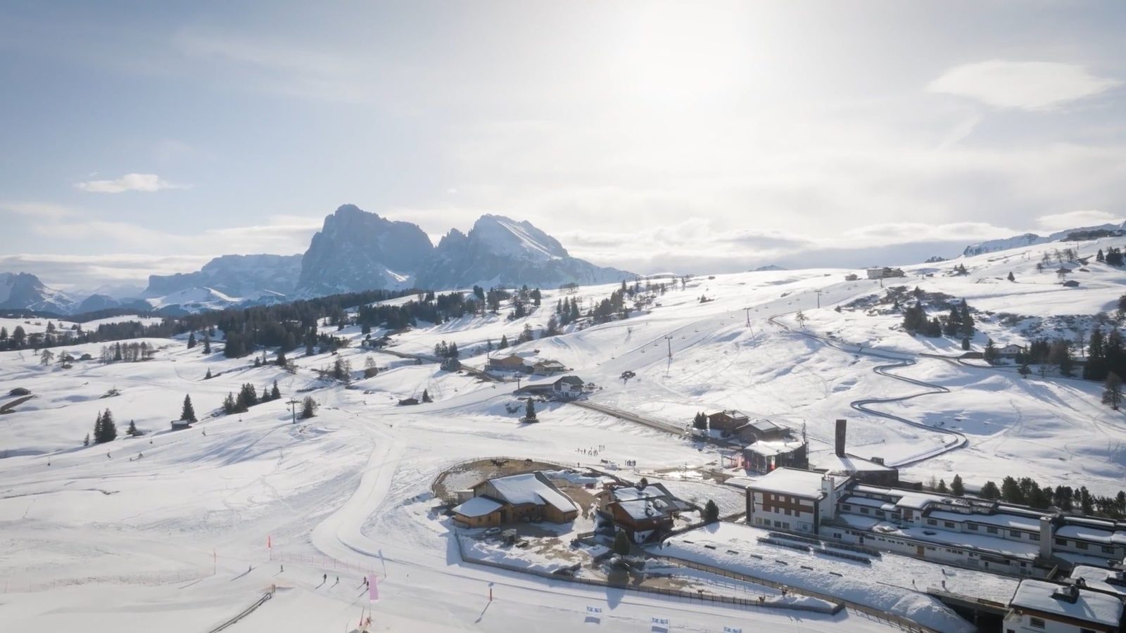 The Alpe di Siusi in winter, with ski lifts and the Sassolungo beyond