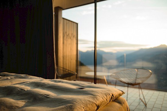 Morning light across a Miramonti room with floor-to-ceiling glass