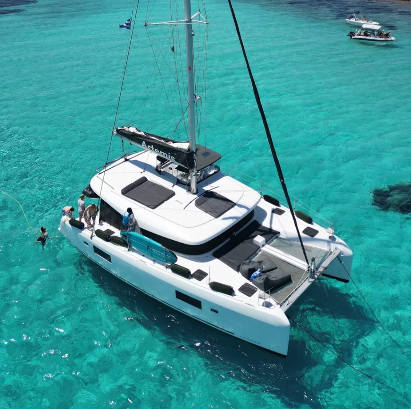 A catamaran anchored in clear water off Antiparos