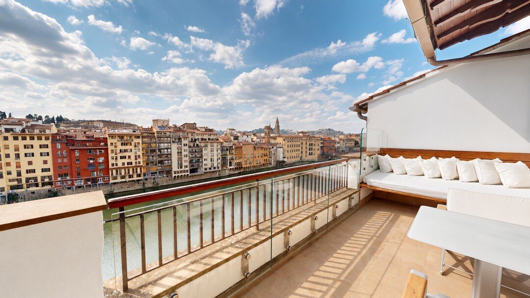 A suite terrace at Portrait Firenze overlooking the Arno and the Oltrarno rooftops