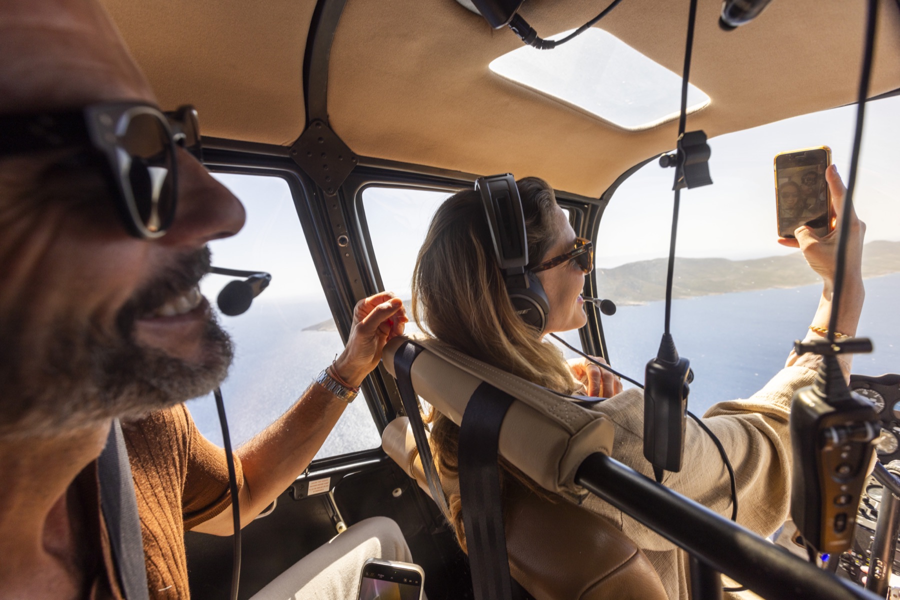 A couple taking in the view from the cabin of a Hoper helicopter