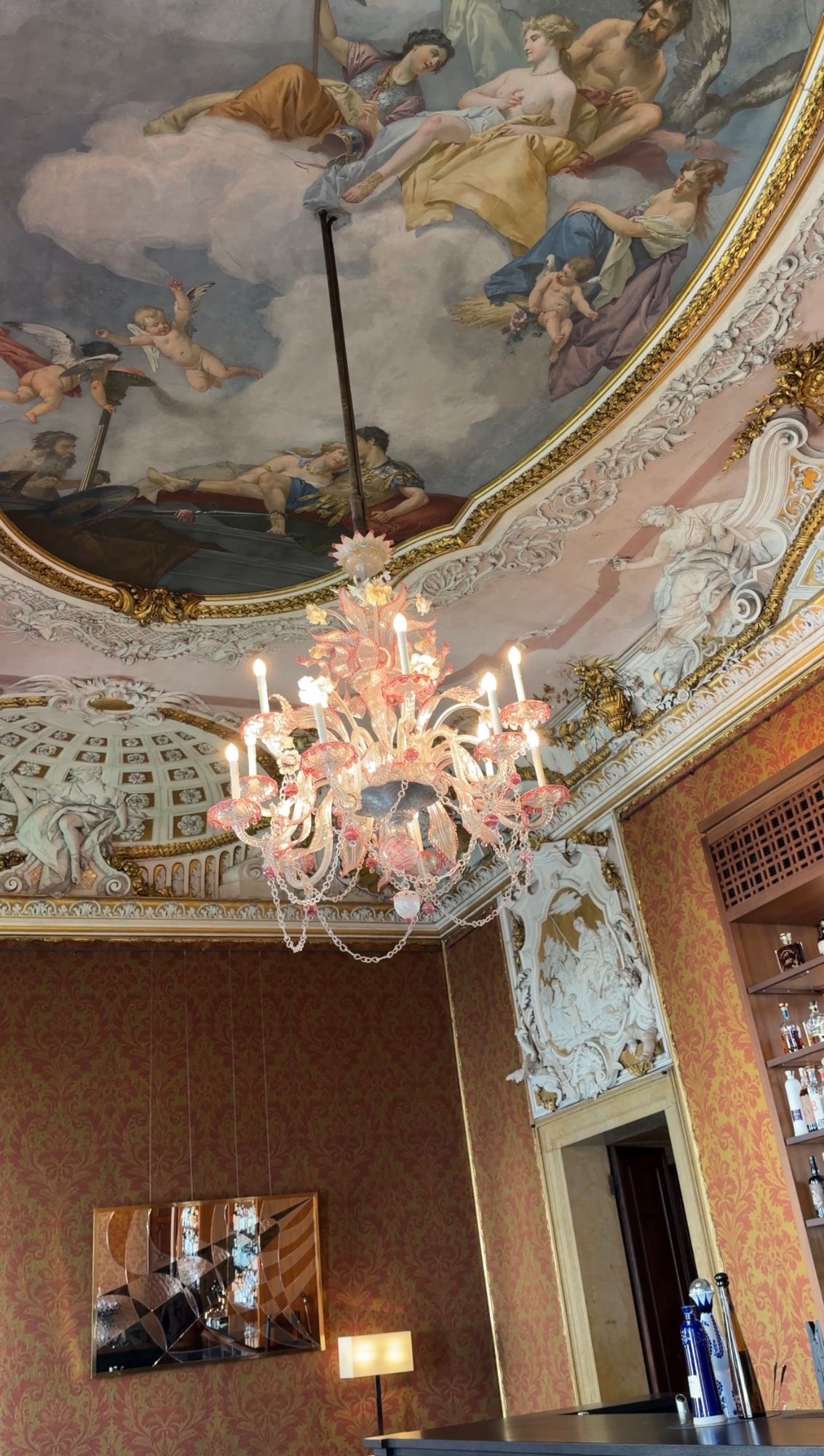 A frescoed ceiling and Murano chandelier at Aman Venice