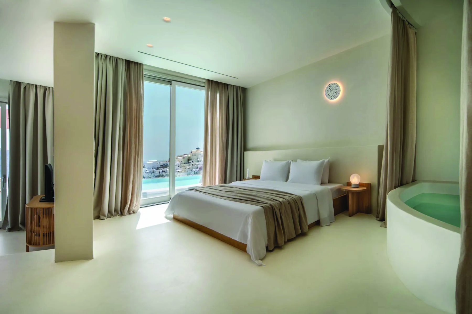 A bedroom with caldera views and a hot tub in the Two Bedroom Villa at Andronis Boutique, Oia