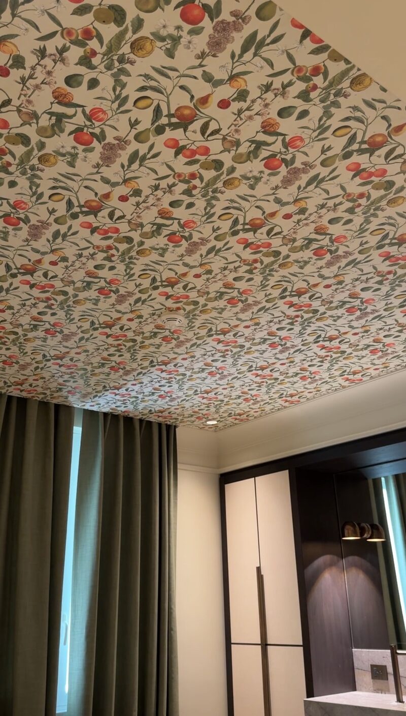A Hotel de Russie room ceiling papered with oranges, pears and blossoms above olive curtains