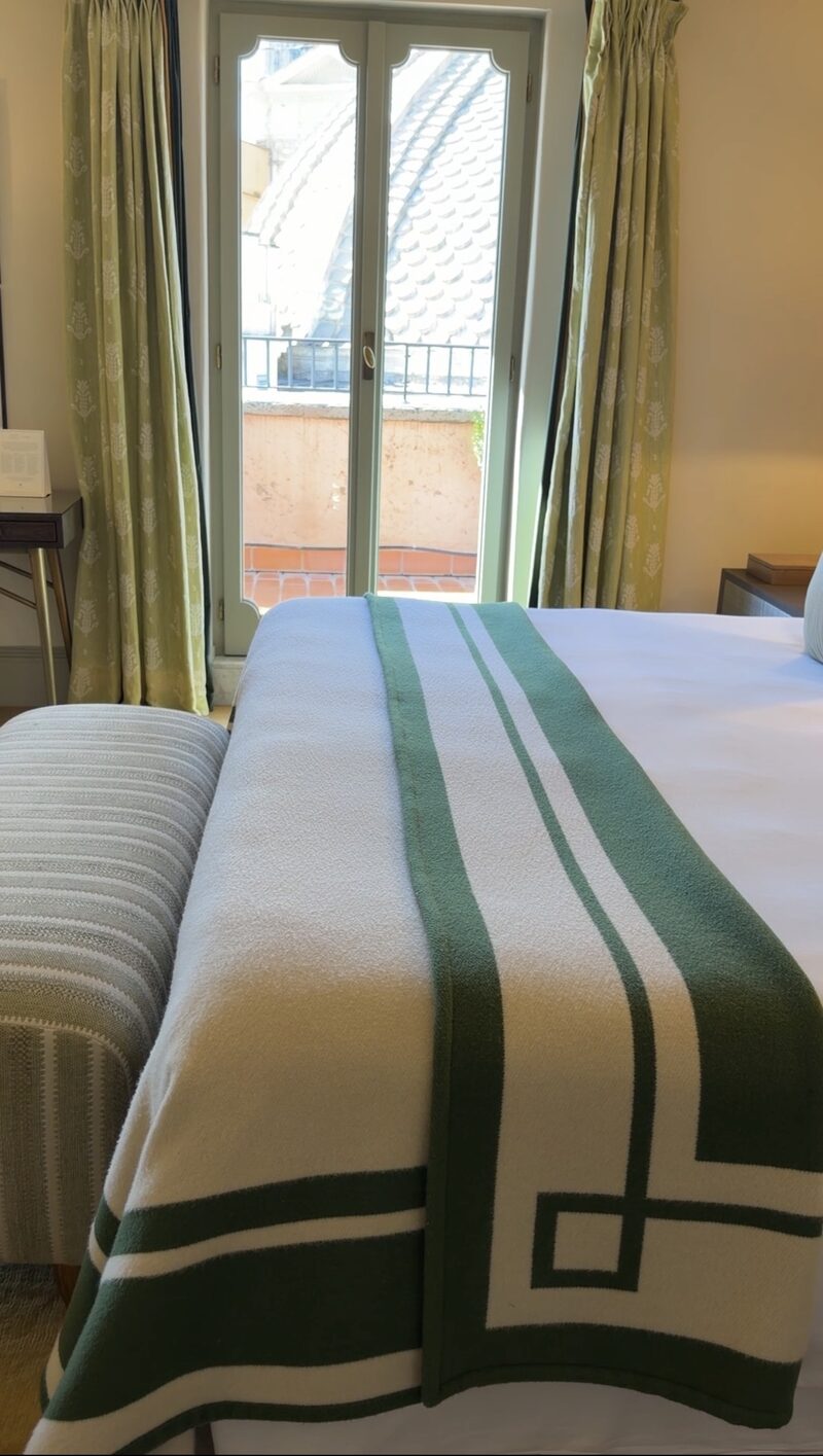 French doors from a Hotel de Russie suite bedroom onto the terrace, with a church dome beyond