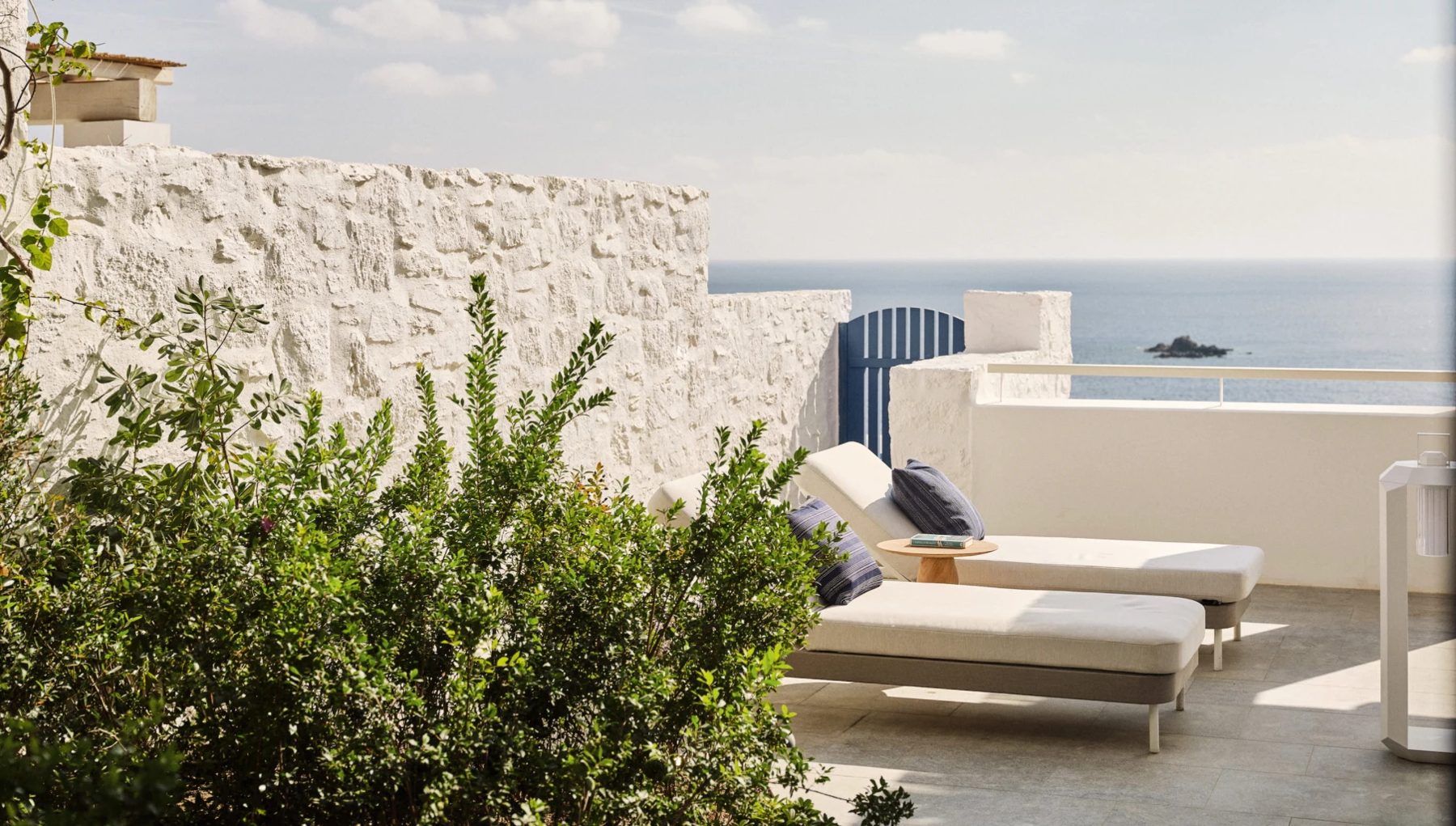 A whitewashed terrace with loungers facing the Aegean at Four Seasons Hotel Mykonos