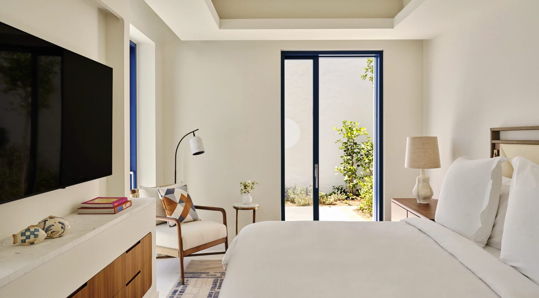 A Syros Villa bedroom opening onto a private garden, Four Seasons Mykonos