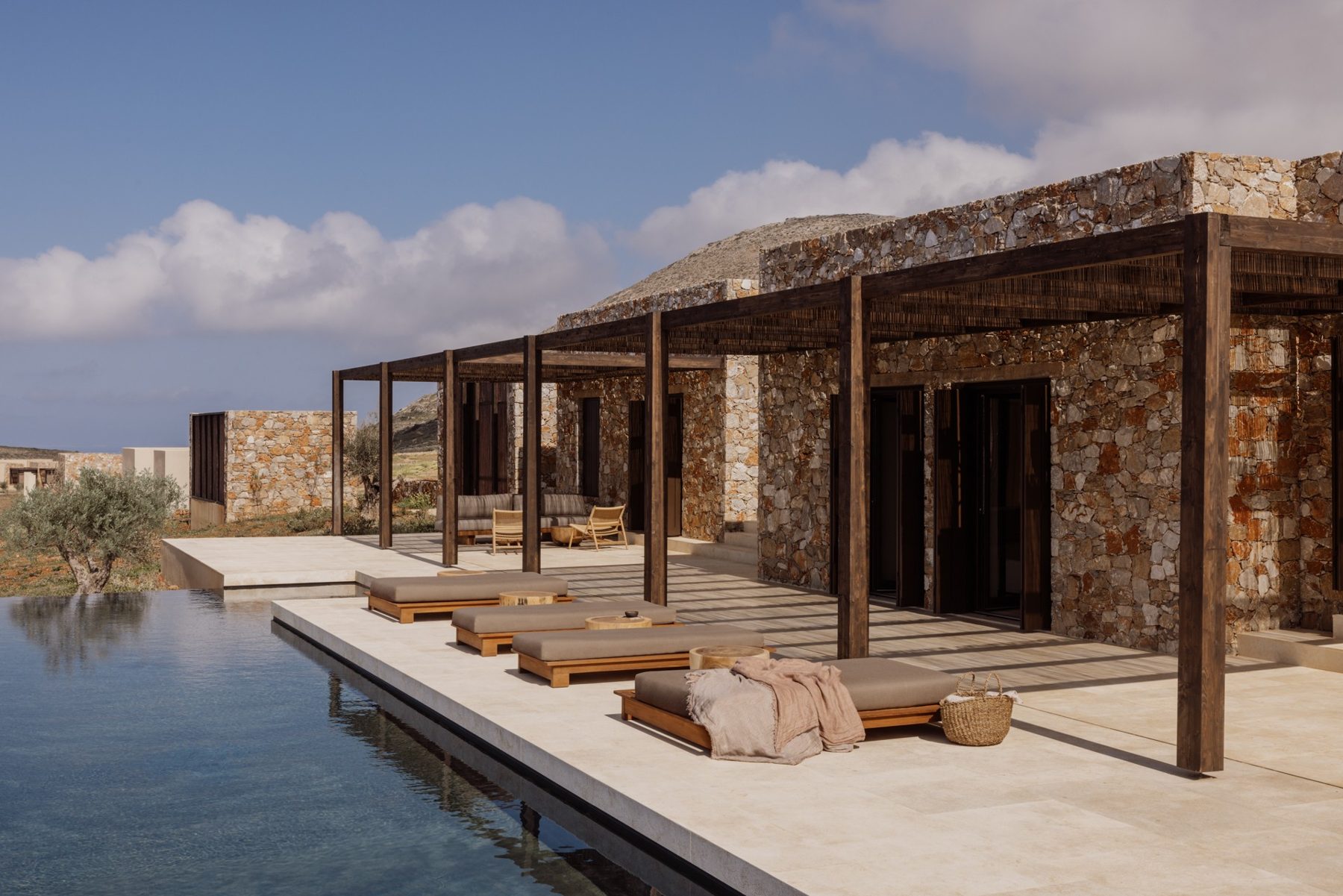 The infinity pool, loungers and stone-and-timber pergola of the Four-Bedroom Villa at Gundari