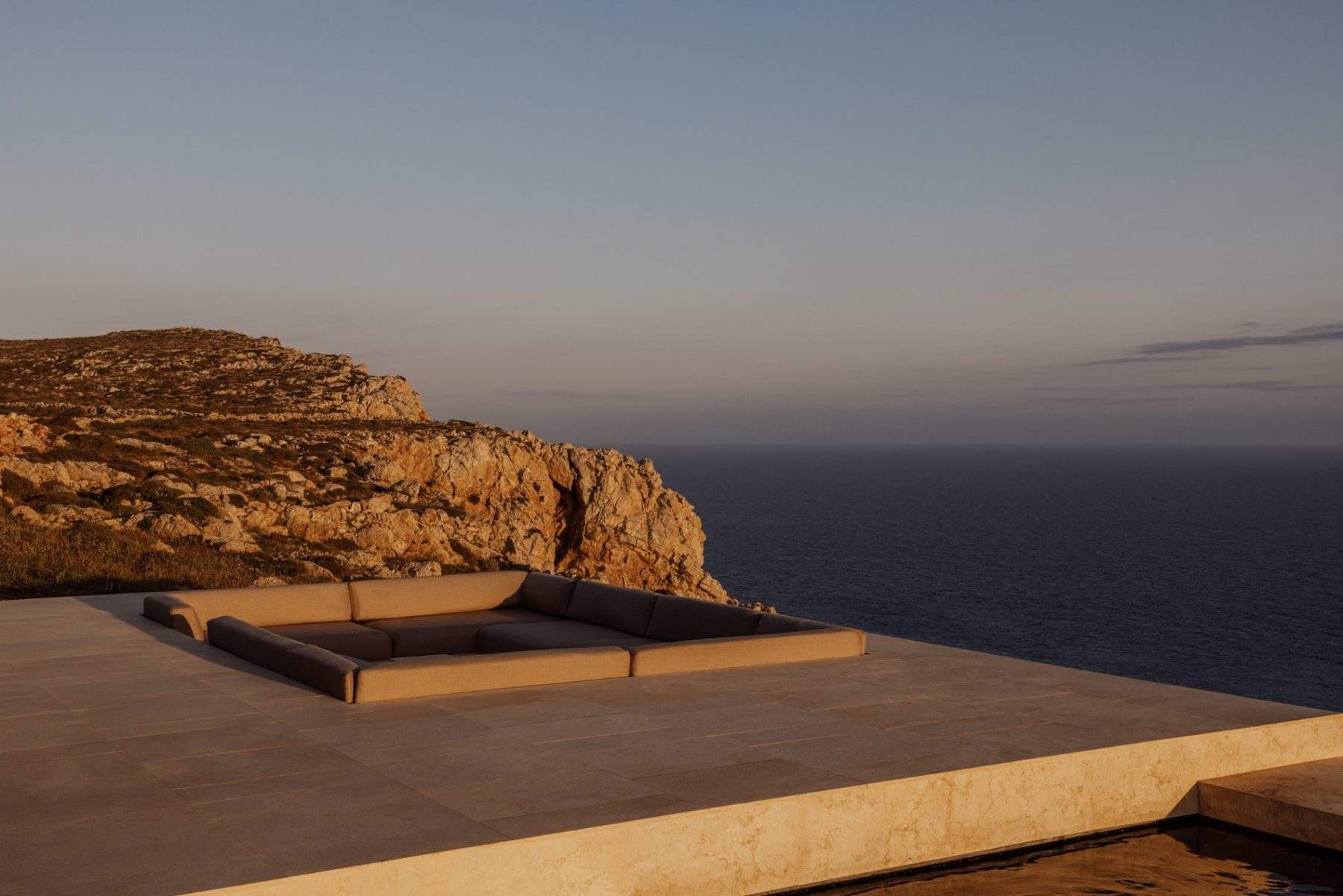 The sunken lounge on the Four-Bedroom Villa terrace at Gundari at sunset