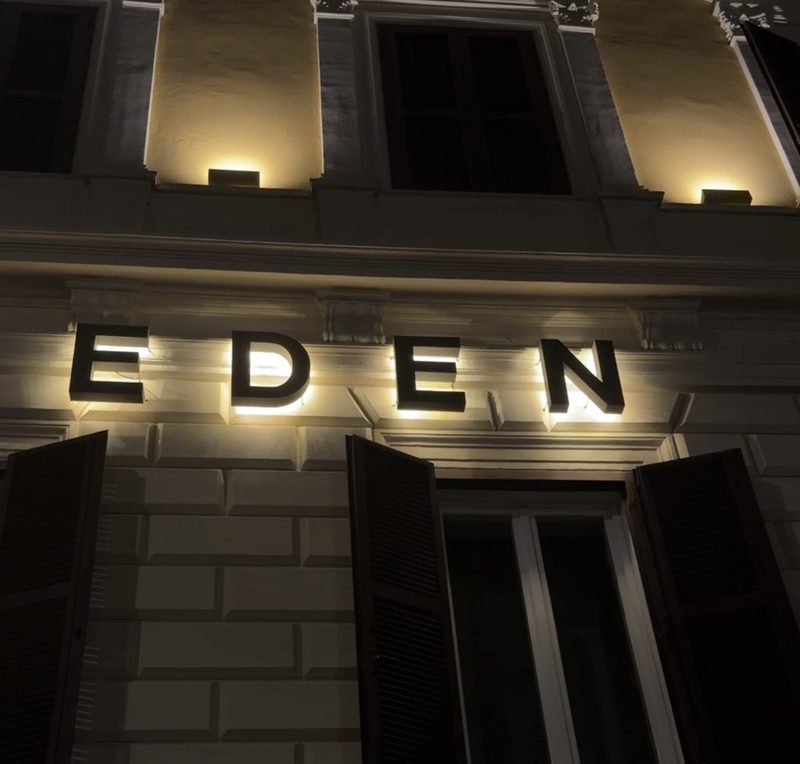 The illuminated EDEN letters on the hotel&rsquo;s facade at night