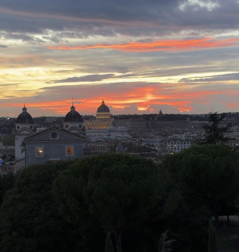 Sunset over the dome of St. Peter&rsquo;s and the rooftops of Rome, seen from Hotel Eden