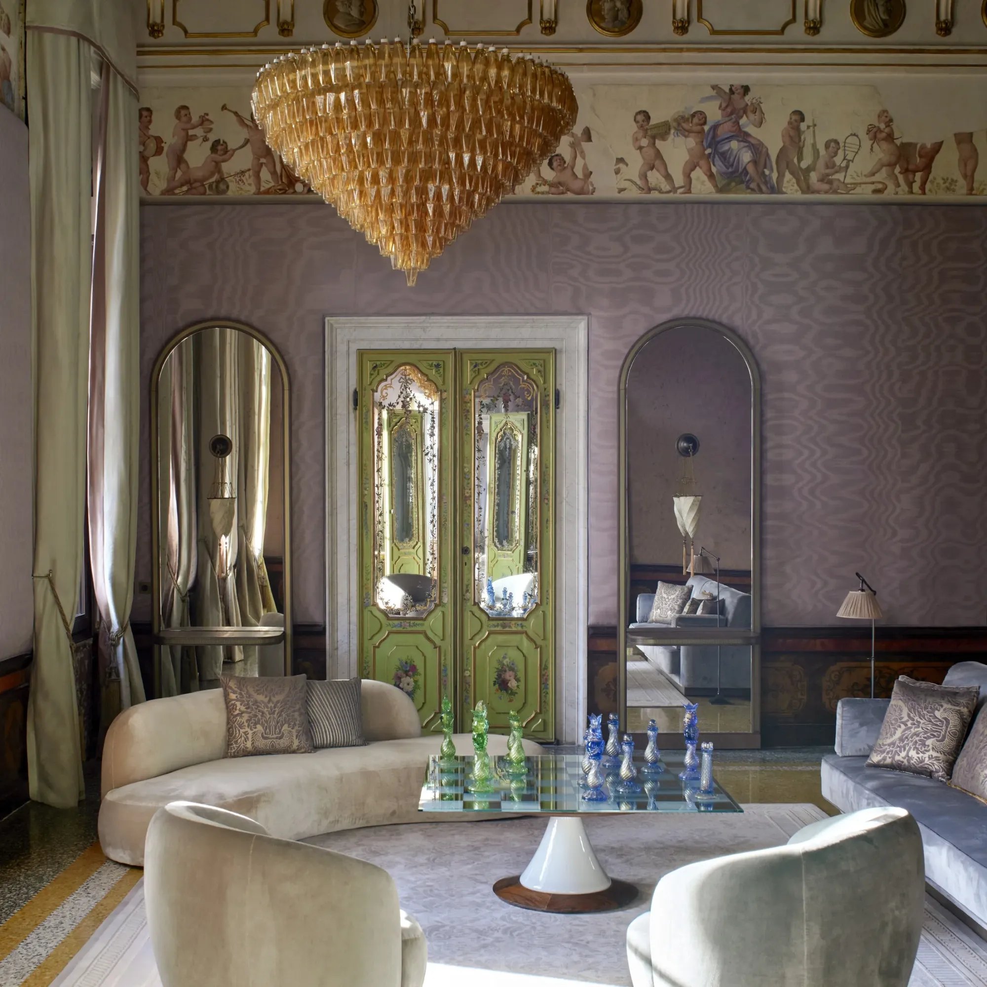 A frescoed suite salon with painted doors, a Murano chandelier and a glass chess set at Orient Express Venice