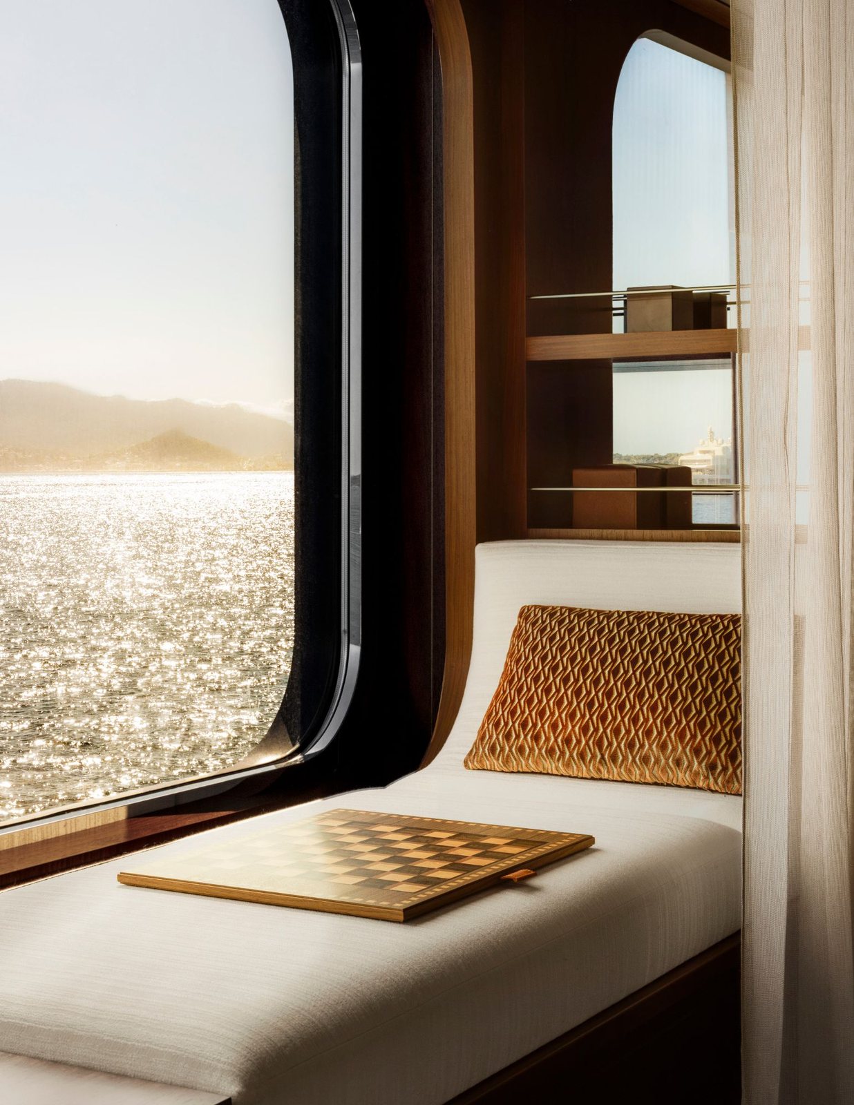 A window seat in a Corinthian suite with a chessboard and the sea glittering outside