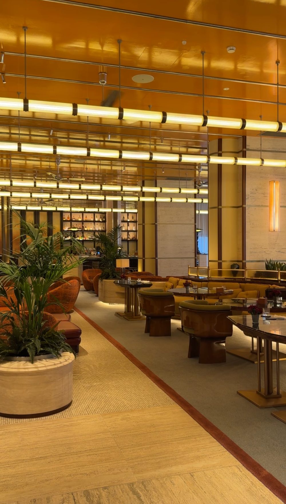 The La Dolce Vita lounge at Rome Ostiense, with gold lacquered ceilings, palms and the bar