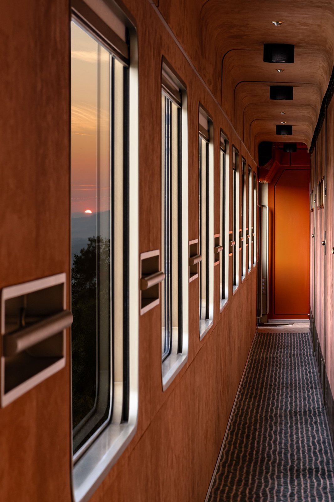 A wood-paneled corridor of windows on La Dolce Vita at sunrise