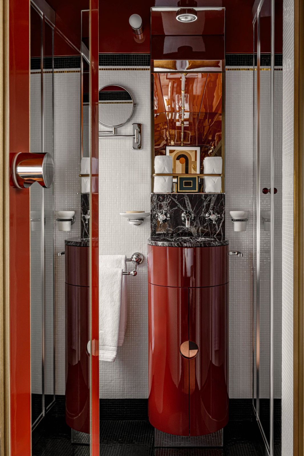 A cabin bathroom in white mosaic and red lacquer with a black marble basin