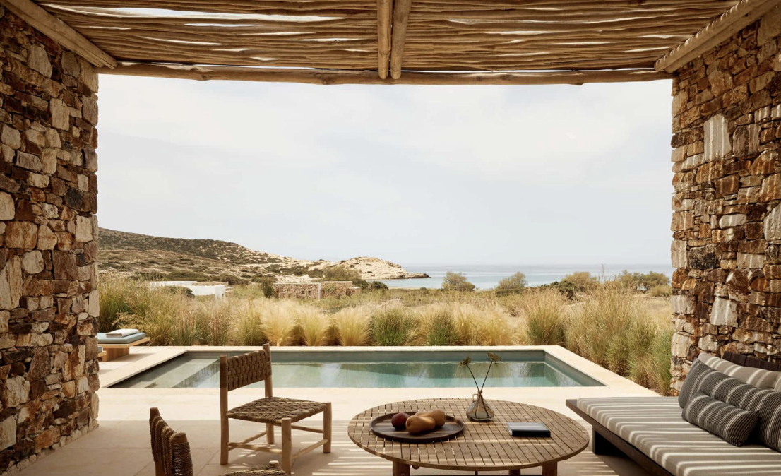 A stone suite and plunge pool looking over the grasses to the sea at The Rooster, Antiparos