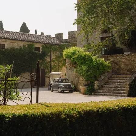 Stone courtyard at Borgo Pignano with a vintage Fiat 500